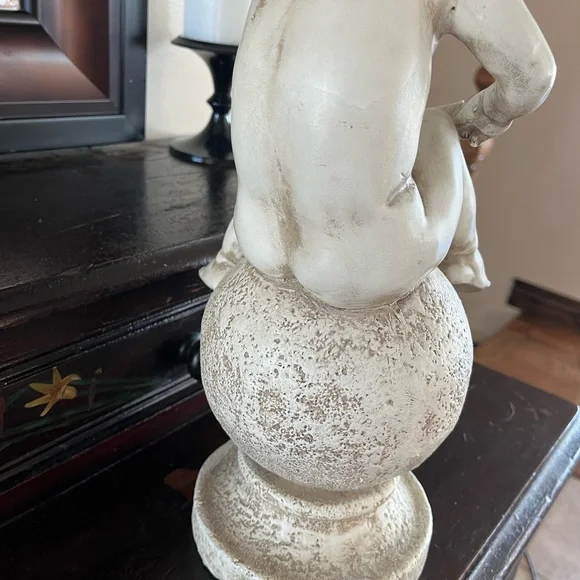 Resin angel statue on a ball 14 1/2 tall 8” wide cream colored